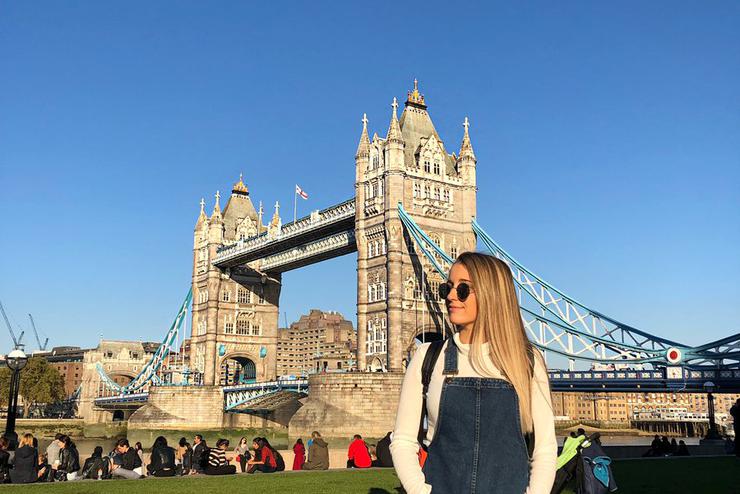 A Southeast student poses in front of the Tower Bridge in London, England while studying abroad.