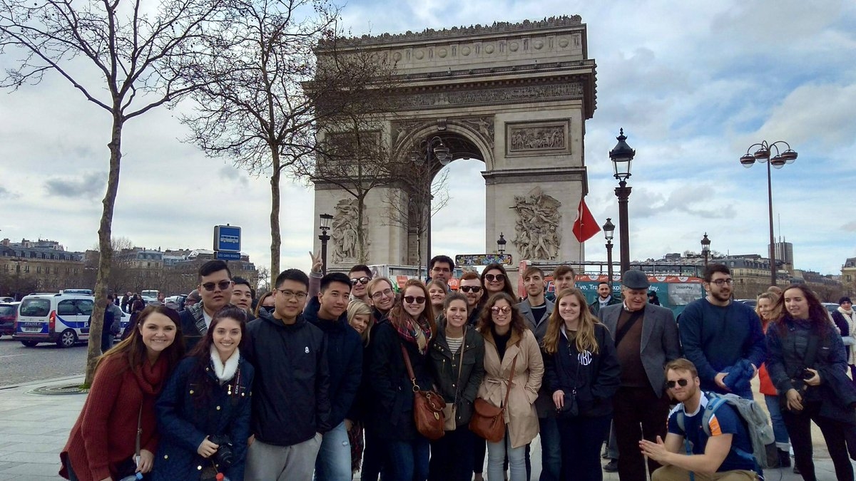 Students pose in front of a famous bridge tower while studying abroad.