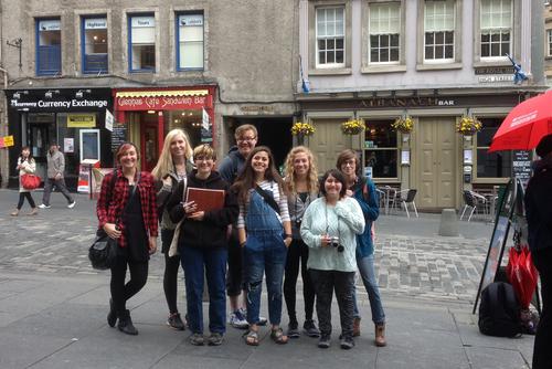 A group of students pose in front of a building during a study abroad.