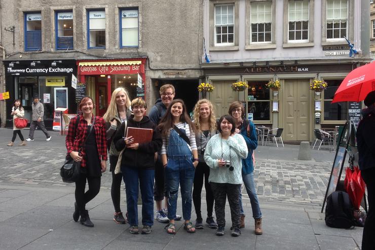 A group of students pose in front of a building during a study abroad.