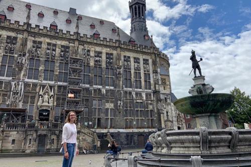 Marlen Hoedebeck stands outside a building in Germany.