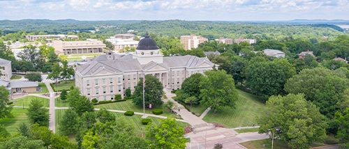a SEMO student who is a member of the center for regional history holds a brick stamped with the words 'cape Girardeau'
