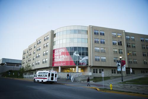 A late afternoon view of Willard Duncan Vandiver Hall as a shuttle drops students off.