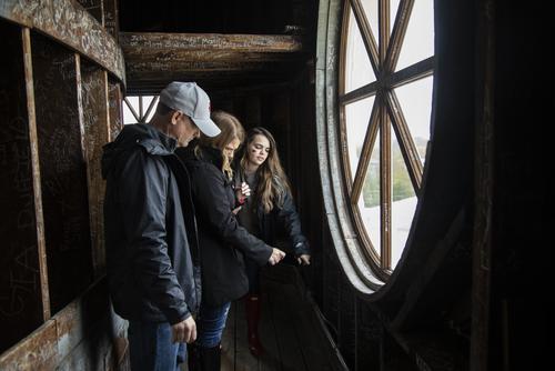 During Homecoming tours, a student and her family read signatures inside the Copper Dome. 