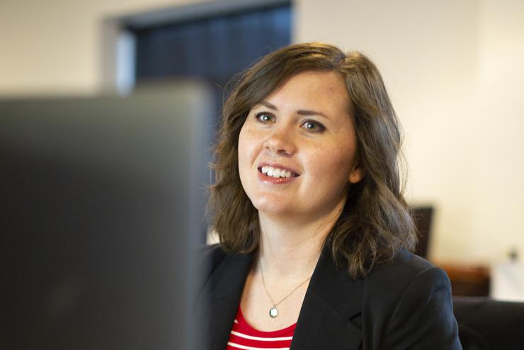 A Southeast alum works on a computer in an office.