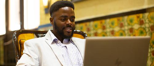 guy sitting working on a computer 