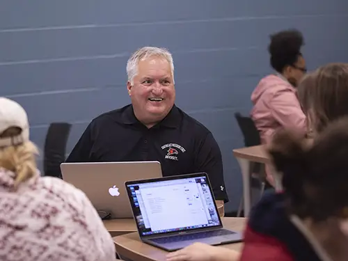 an adult learner nontraditional SEMO student sits in class in a group with his younger classmates