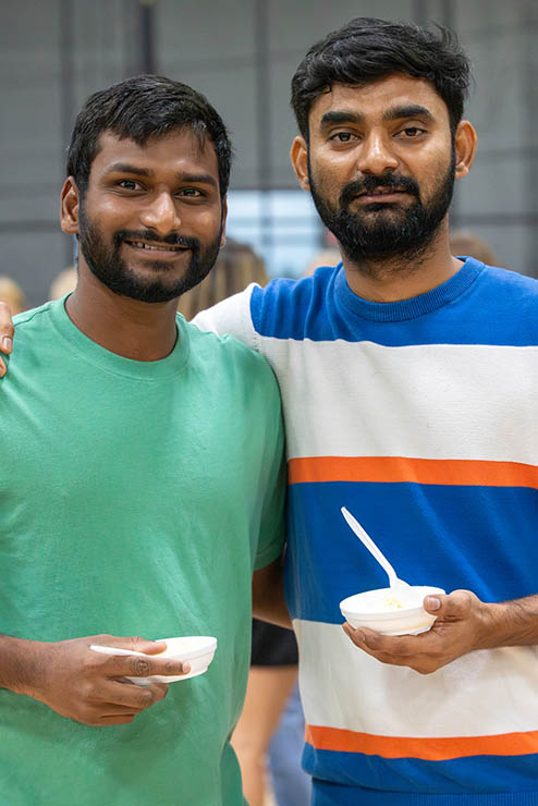 two international students pose together for the camera during the welcome back ice cream pigout