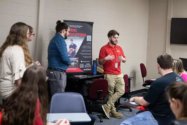 a SEMO employee stands at the front of a group and gives a presentation