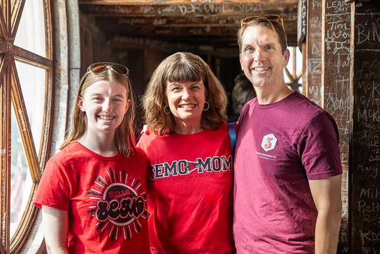 a SEMO student and her parents pose for a photo inside the dome