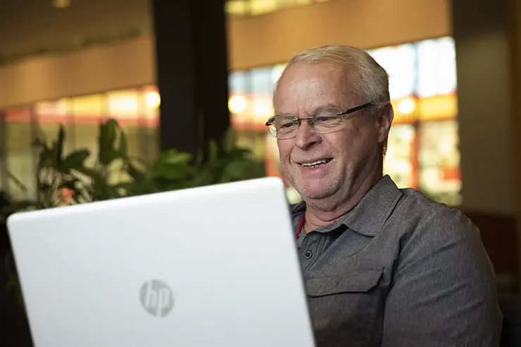 a nontraditional SEMO student sits at his laptop to work