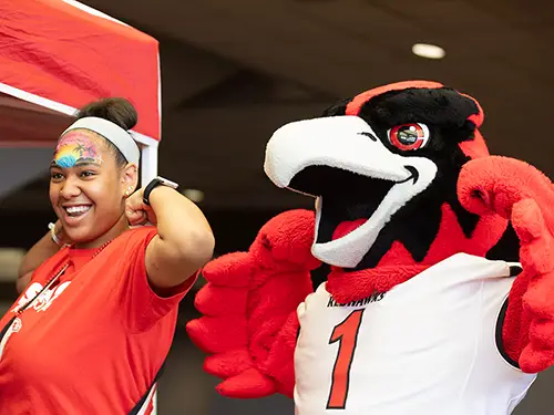 a SEMO student poses with Rowdy the Redhawk
