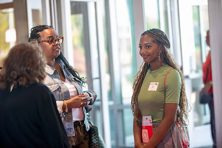 a SEMO student and her parent listen to a SEMO admission employee answer questions