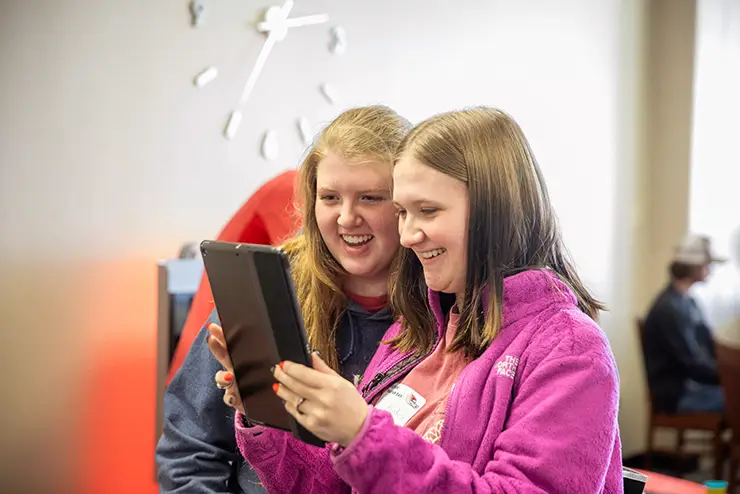 two high school students share a tablet during a SEMO event