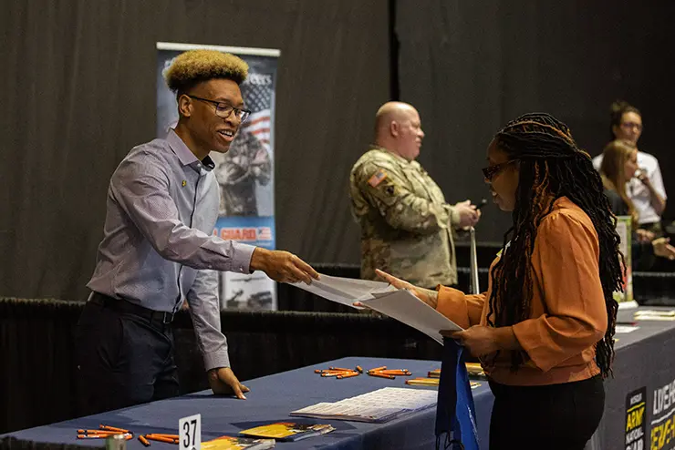 a student interacts with a business representative at the SEMO career fair