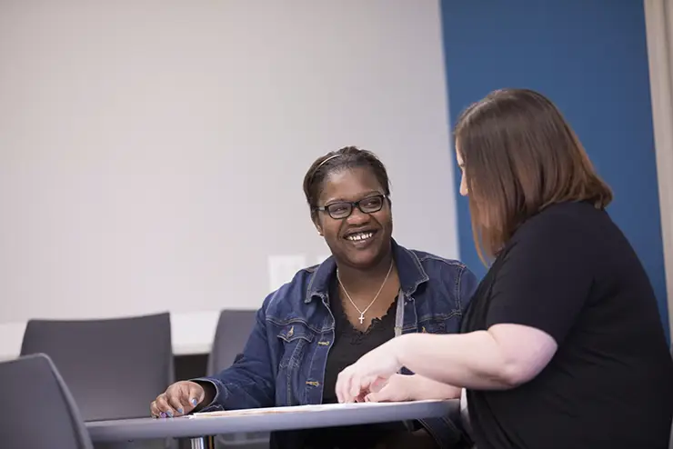 a nontraditional SEMO student and an advisor sit together at a table