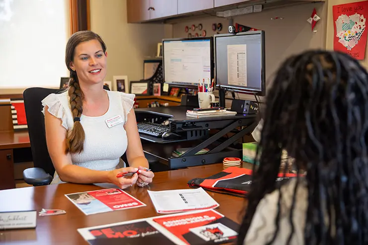 a transfer coordinator sits in her office with a student