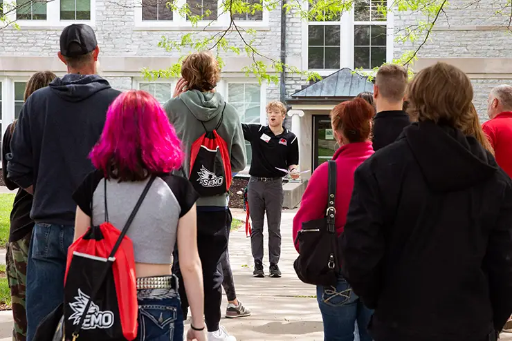 a SEMO admissions tour guide speaks to a group of prospective students taking a campus tour
