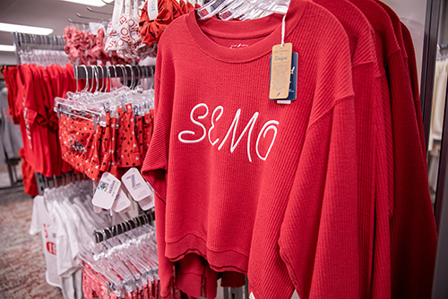 A SEMO Redhawks t-shirt hanging on a rack in the University Bookstore.