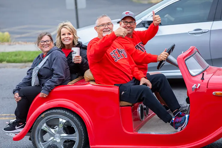 A group of family and friends take a selfie during the Homecoming parade. 