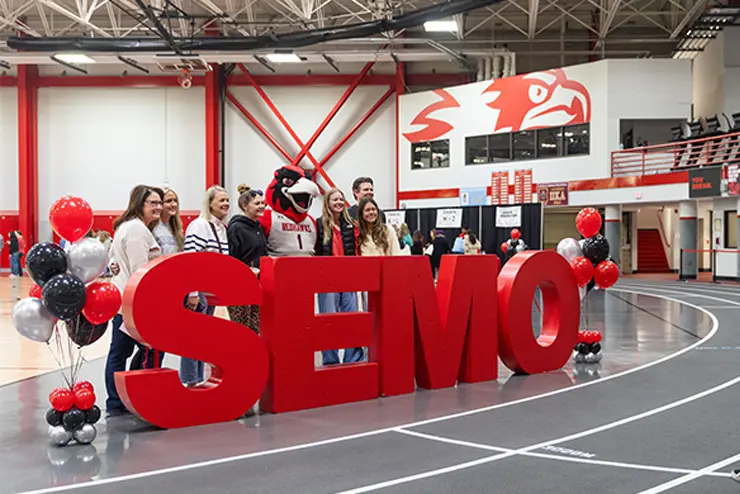 SEMO Sign with students in the Recreation Center
