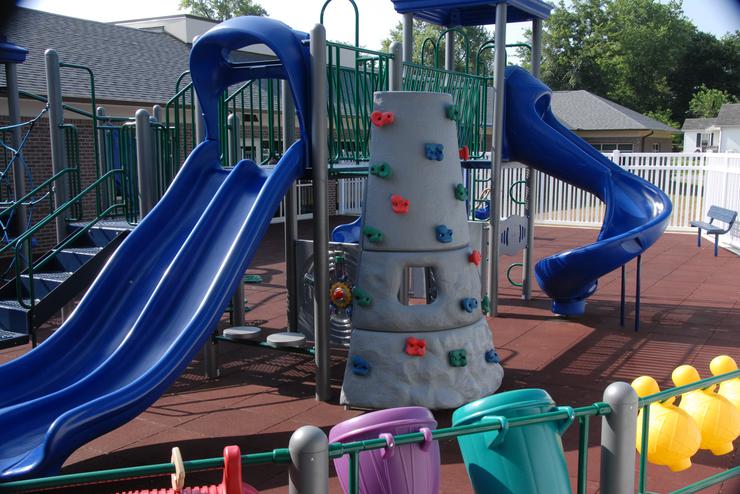 The playground, with slides and a rock wall, located behind the University Autism Center. 