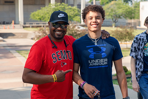 Family walking into the Academic to start their first step as becoming a redhawk.