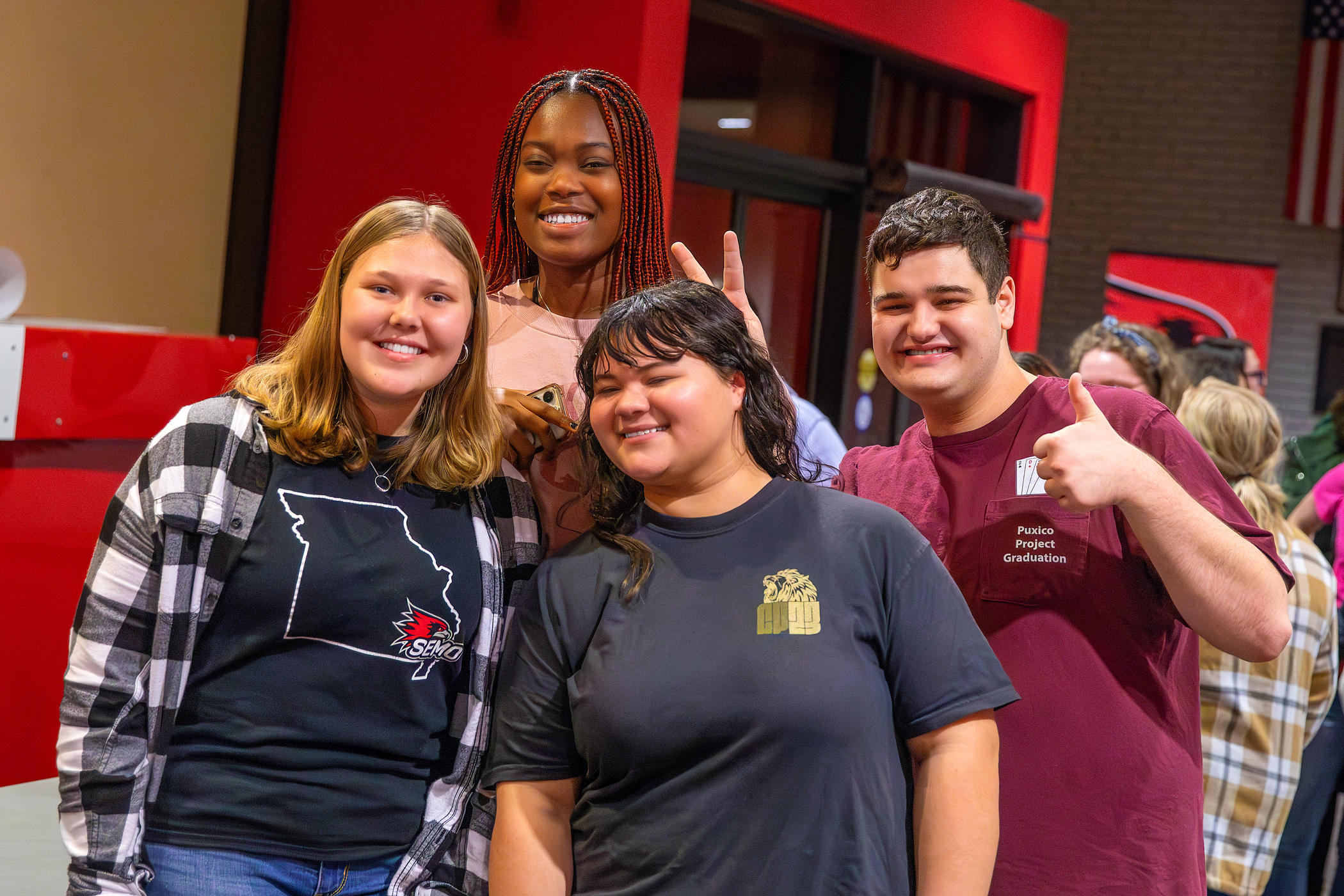 Group of smiling students posing for the camera during Late Night Breakfast.