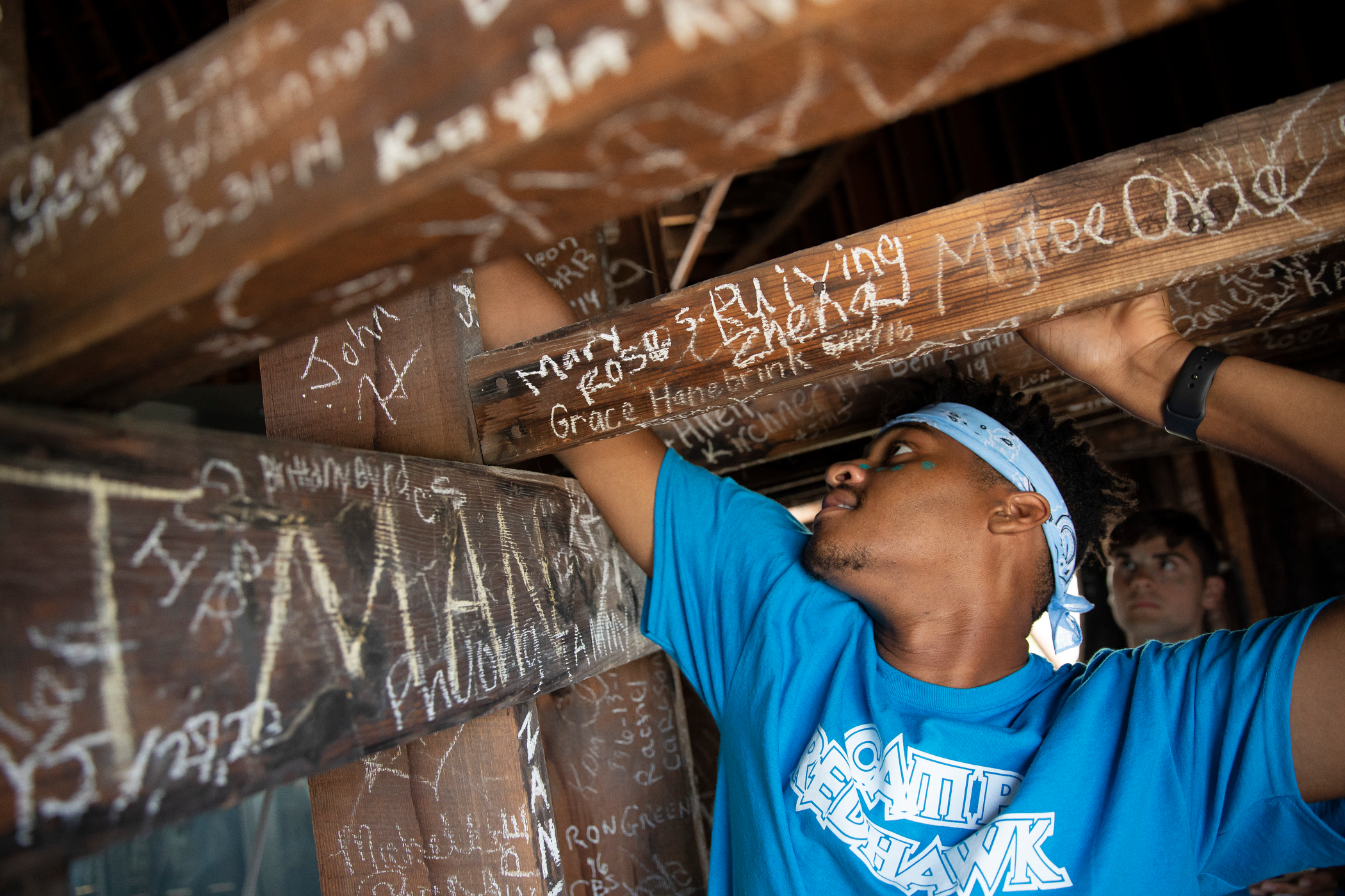 Student signing the Dome during Camp Redhawk, a beloved tradition. 