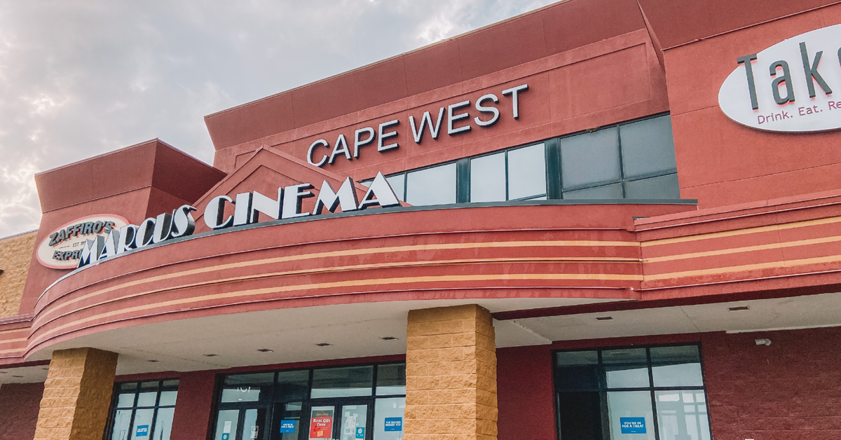 A red building with Marcus Cinema and Cape West signage on the front.