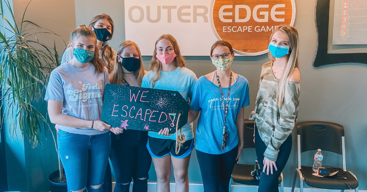 A group of women pose with a sign that read "We escaped"