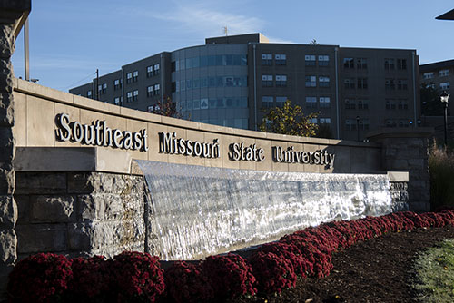 Sunny day at Southeast Missouri State University's Welcome Fountain, where the sunlight glistens on the water's surface, creating a warm and inviting atmosphere on the campus.