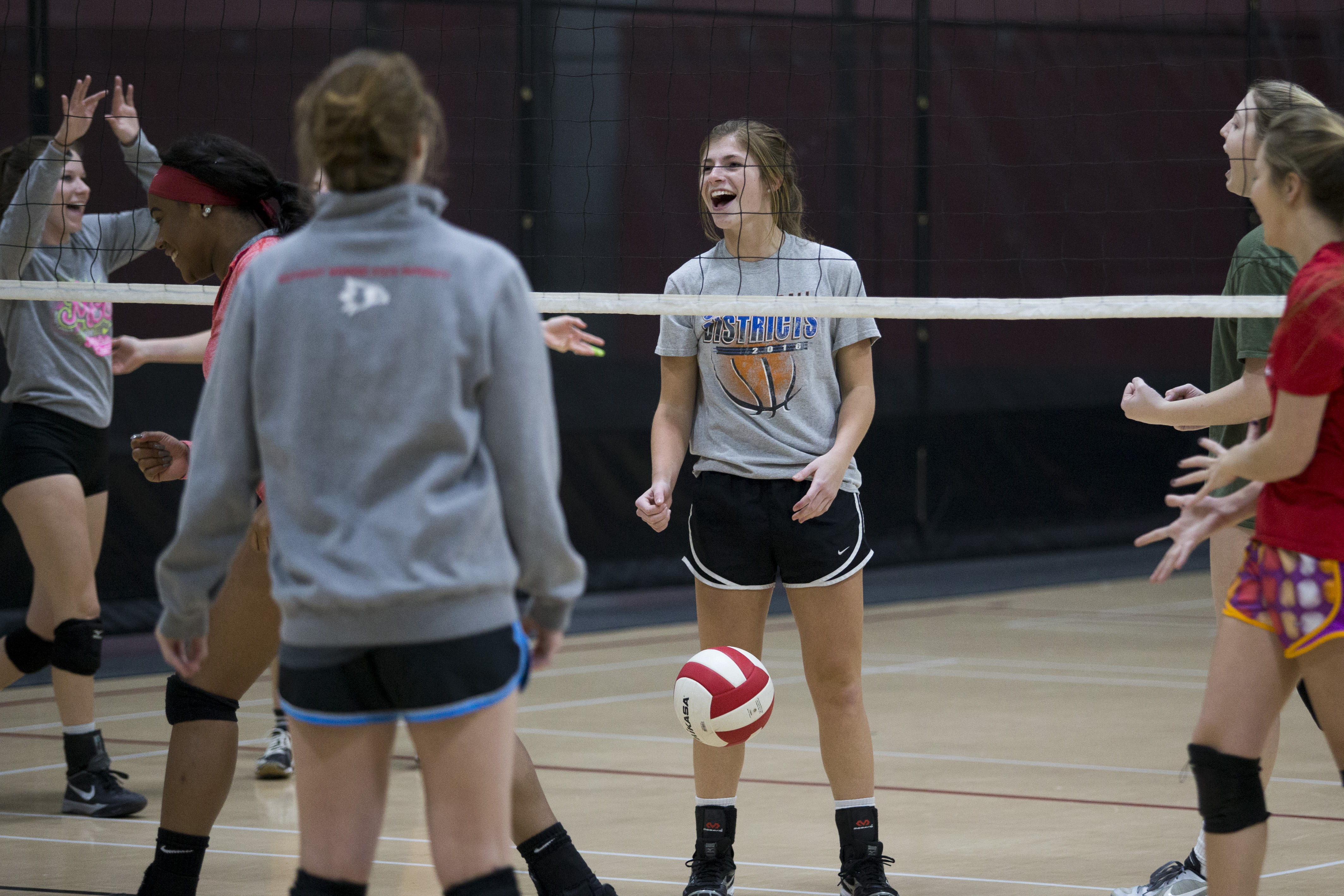 Girls cheering after getting a point during an intramural volleyball game