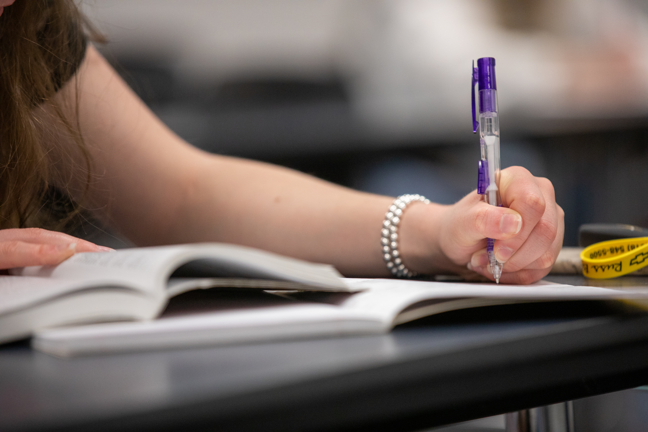 A close up of student taking notes with a mechanical pencil