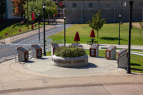 Sunny day at the Southeast Missouri State University's National Pan-Hellenic Council Plaza, where the vibrant colors of the plaza's design are illuminated by sunlight, creating a welcoming and lively atmosphere.