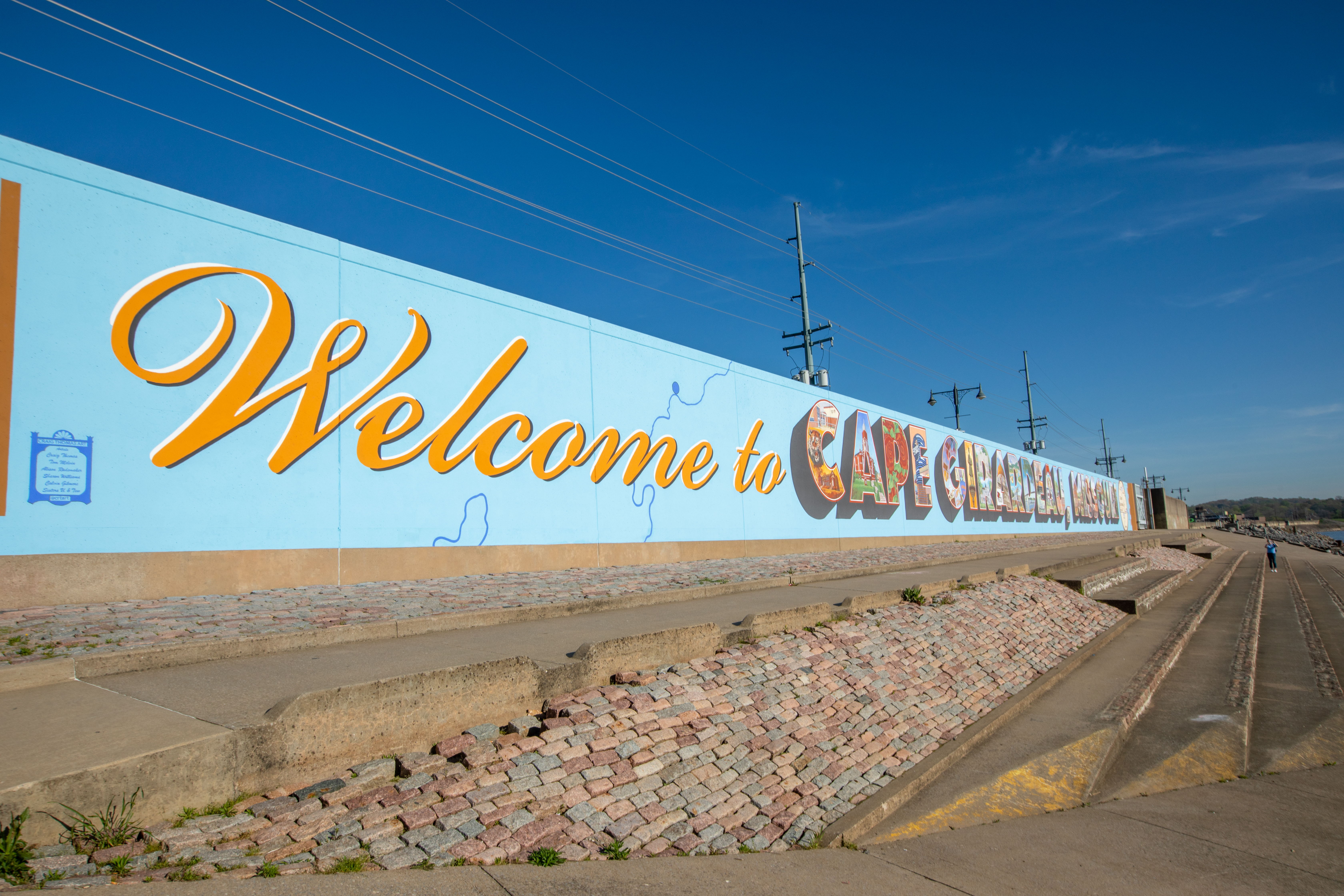 Landscape photo of the riverfront with bright colors and blue skies.