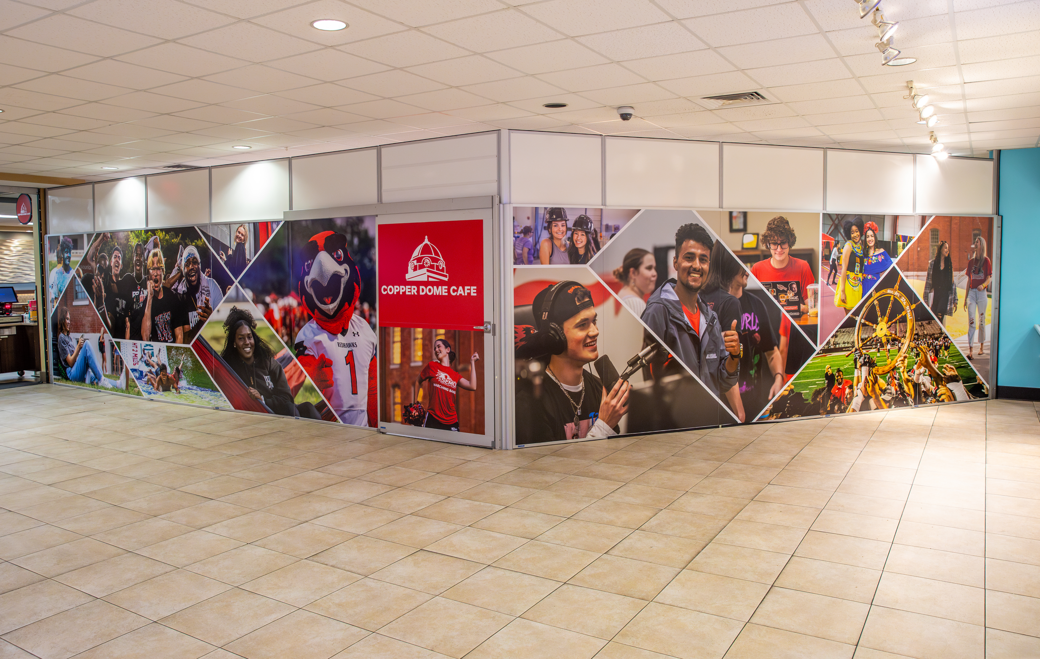 Wall graphic at the Copper Dome Cafe, featuring student photos enhancing the cafe's inviting atmosphere.