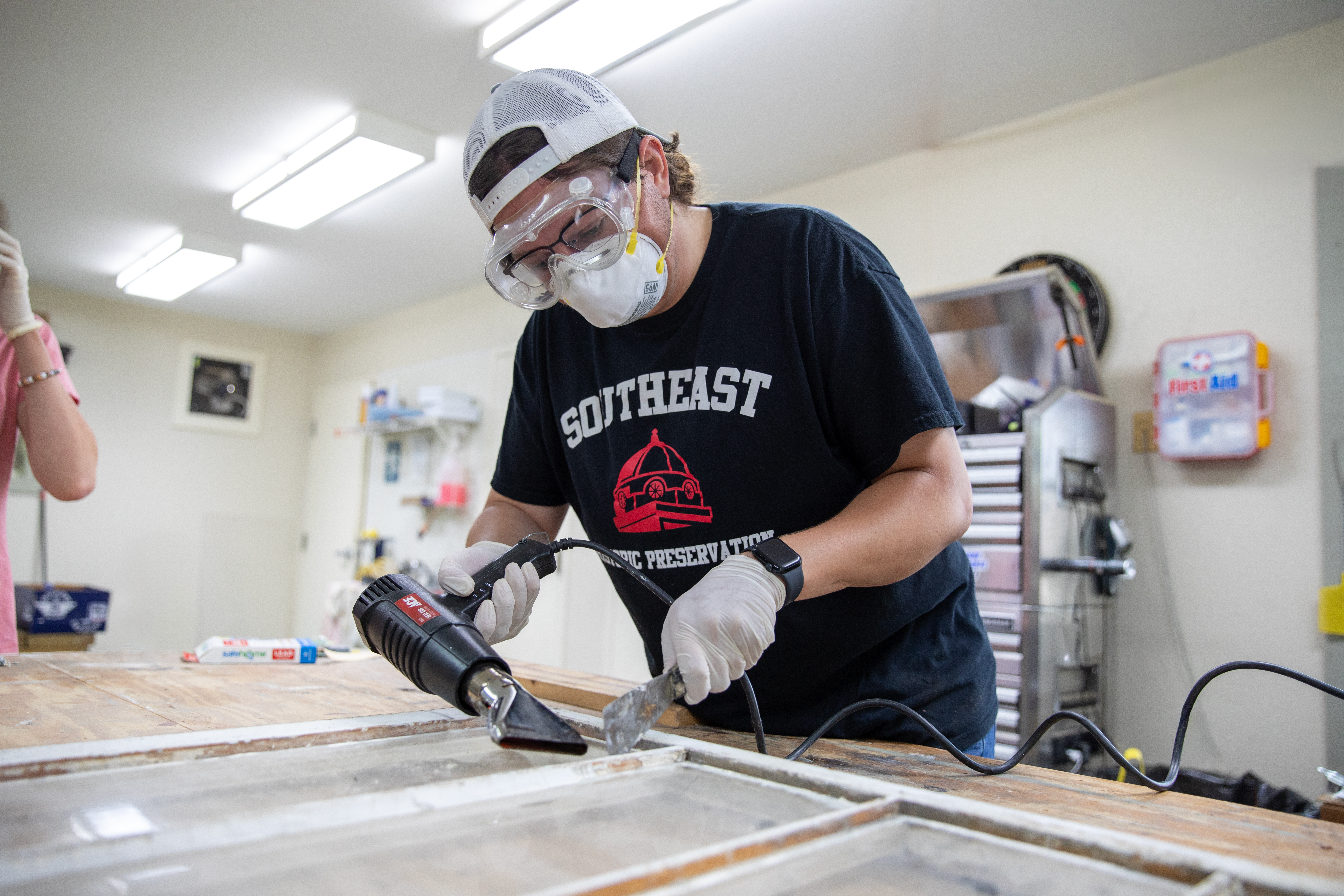 Historic Preservation student preserving an old window.