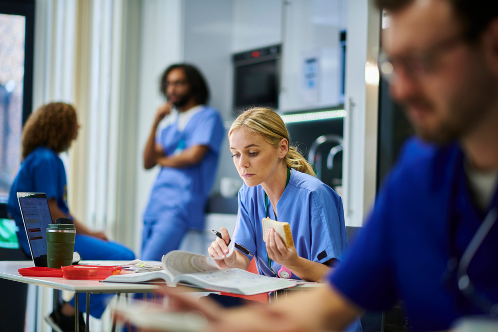 A registered nurse studies for their BSN during a break at work. 