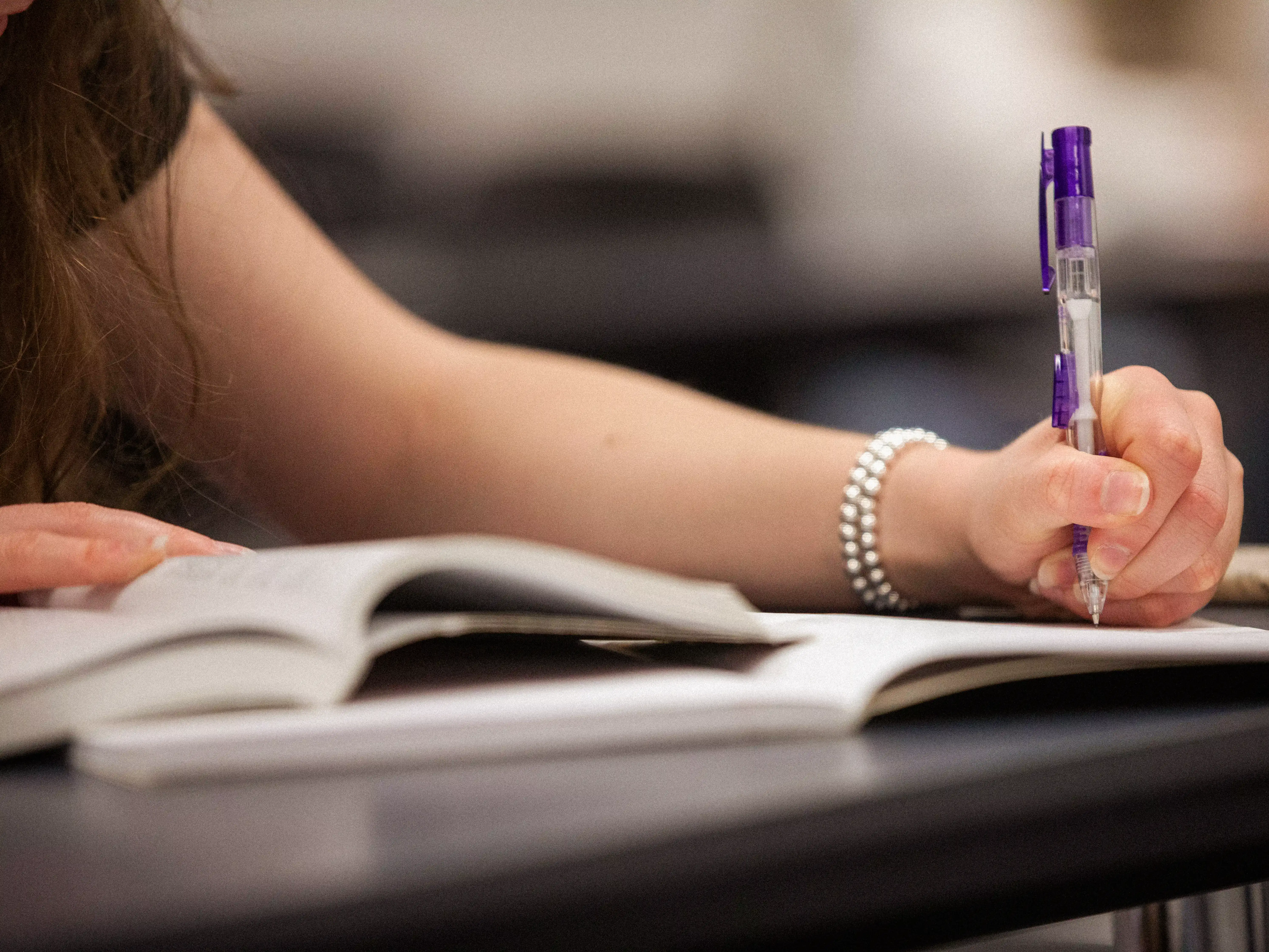 student writing in ntoebook for her AI proof career at SEMO