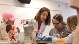 A professor teaches students in an anatomy classroom.