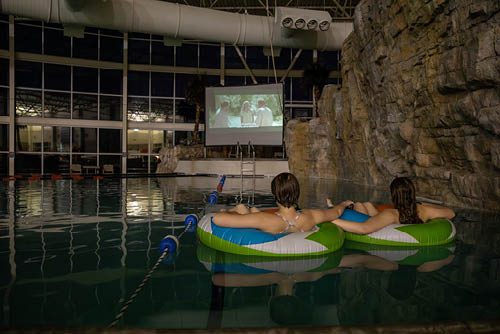 Two friends watch a movie together in the Student Rec Center's Aquatic Center