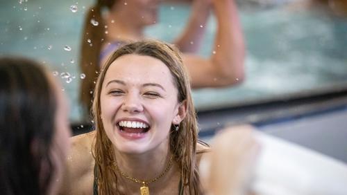 A student smiles while enjoying the aquatic center during CampRedhawk