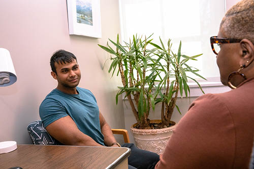 A student and counselor smiling in conversation.