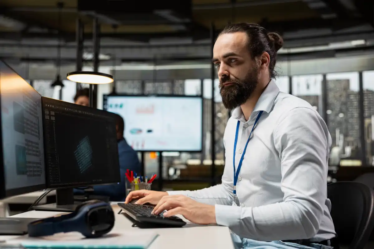 A data scientist works on a computer in an office.