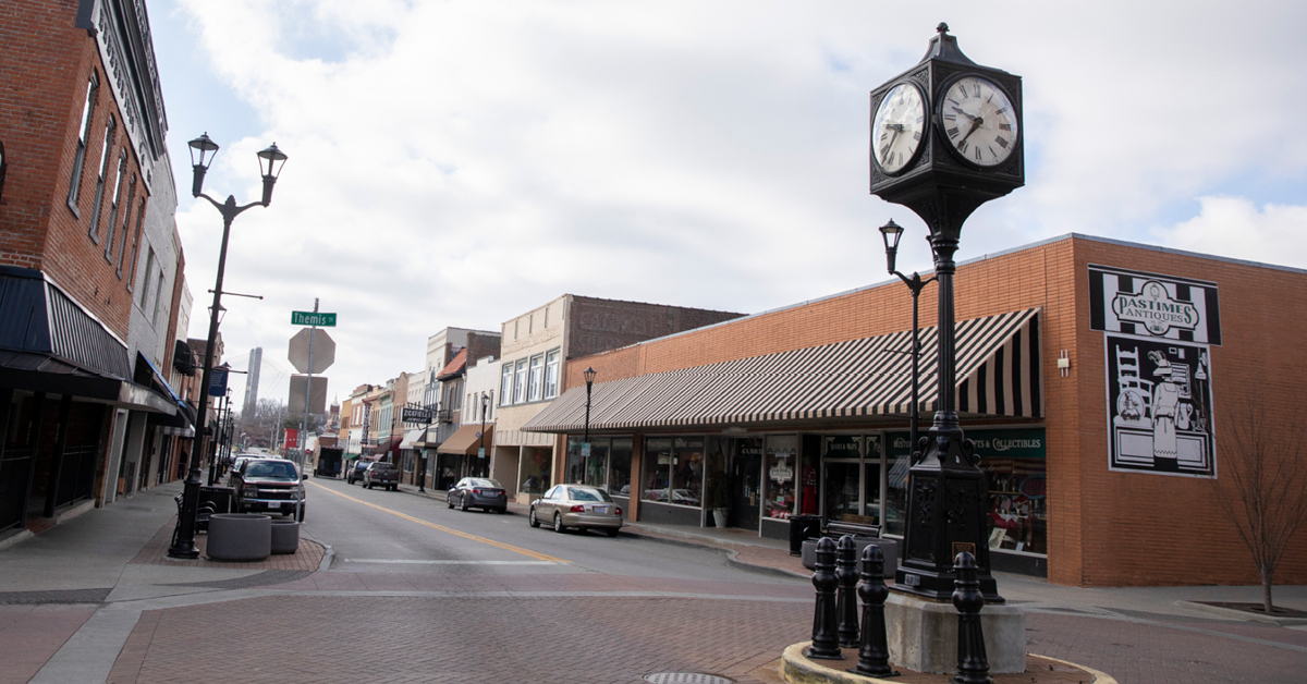 Downtown Cape, featuring a black clock tower and various store fronts.