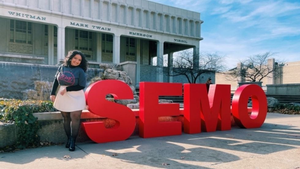 Layla Bouzihay poses next to red SEMO letters near Kent Library