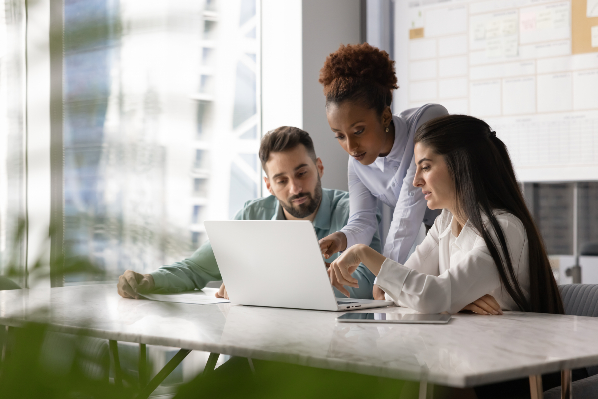 A marketing manager reviews a campaign plan with other team members.