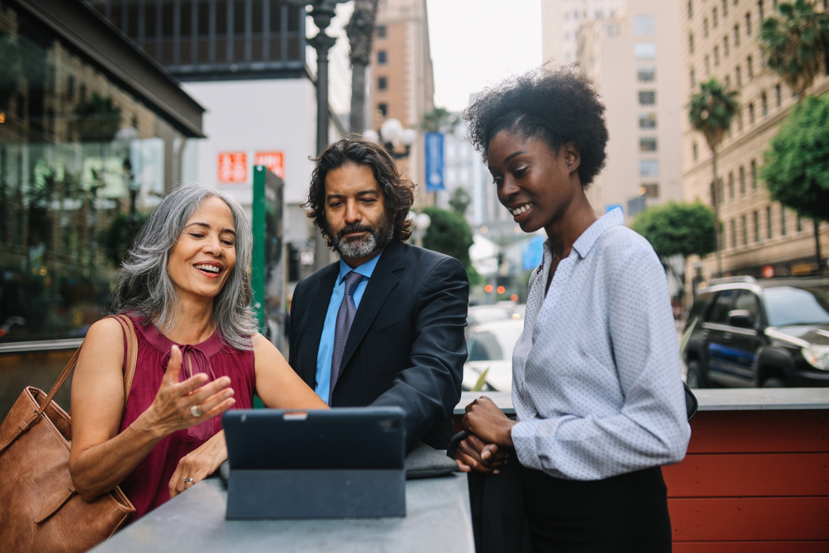 A public administrator talking with colleagues on a city street.