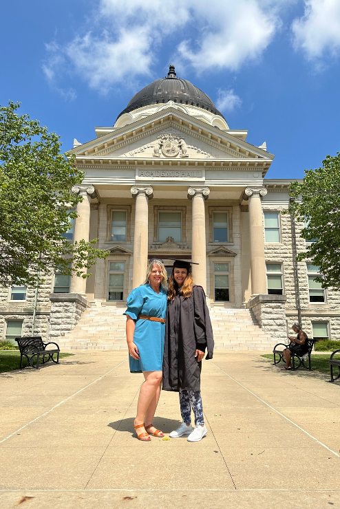 Dr. Nicholls and Dr. Gupta pose in front of Academic Hall